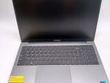 an open laptop computer sitting on top of a white table