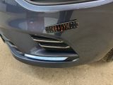 a close up of a car ' s bumper with a sticker on it