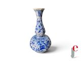 a blue and white vase sitting on a white surface