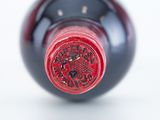 a close up of a wine bottle with a red label