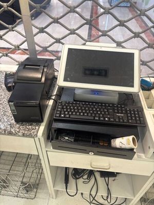 a laptop computer sitting on a desk with a printer on it