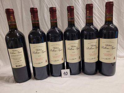 six bottles of red wine are lined up on a table