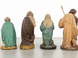 three figurines of jesus and three wise men in a row