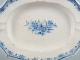 a blue and white plate with a flower design on it