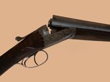 an old gun with a wooden handle on a beige background