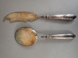 two spoons and a spoon with a handle on a table