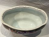 a white bowl with a design on it sitting on a table