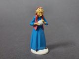 a figurine of a woman holding a bowl of food