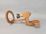 a small wooden object with a wooden handle on a table