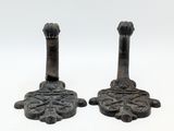 pair of antique cast iron candlesticks in the shape of a lion ' s paw