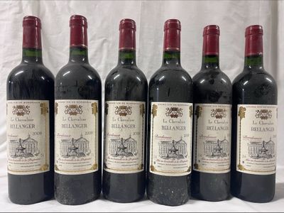 six bottles of wine are lined up on a table