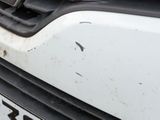 a close up of a car ' s front bumper with rust on it