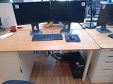 a desk with two monitors and a keyboard on it