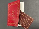 a red book with gold writing on it sitting on a table