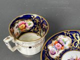a close up of a cup and saucer on a table