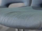 a close up view of a blue chair with a striped seat