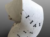 a white vase with black and white designs on it