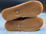 the soles of a pair of pink shoes are stacked on top of each other
