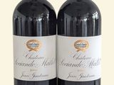 two bottles of wine sitting next to each other on a table