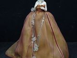 a figurine of a woman wearing a dress and a necklace