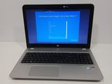 a laptop computer sitting on a table with a blue screen