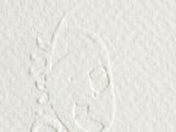 close up of a white paper with a drawing of a face on it