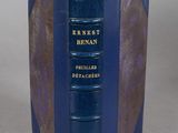 an old book with a blue cover sitting on top of a table
