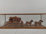 a wooden display case with a horse drawn carriage