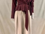 an image of a mannequin mannequin wearing a maroon top and beige pants