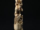 an antique carved ivory figurine of a woman and child
