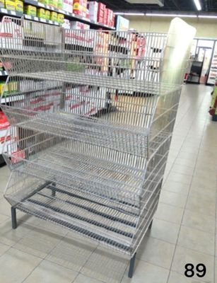 a metal rack in the middle of a grocery store