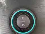 an image of a close up of a speaker with a button on it