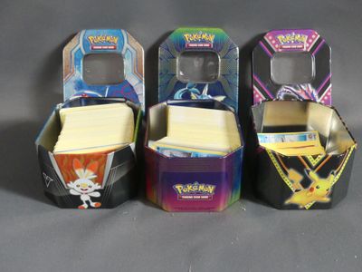 three boxes of pokemon cards are lined up on a table