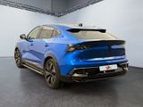 the rear end of a blue car in a showroom