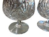 two wine glasses sitting next to each other on a table