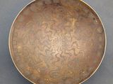 a close up of a metal bowl on a table