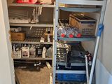 a small room with a shelf with many items on it