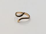 a close up of a gold ring with a curved design