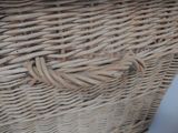 a wicker basket with a handle on a table