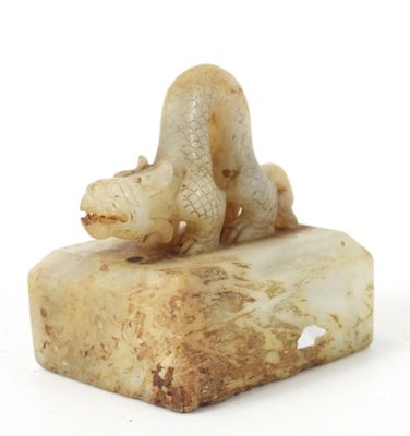 a statue of a turtle on a rock on a white background