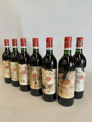 six bottles of red wine lined up in a row on a table