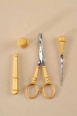 a pair of scissors, a comb, and a pair of scissors on a table
