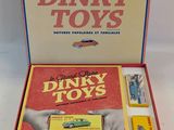 a box with a book and toy cars inside of it
