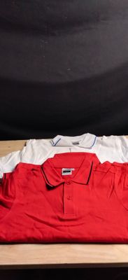polo shirt on a wooden table next to a black backdrop