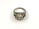 a close up of a diamond ring on a white surface