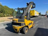 a yellow forklift that is parked on the side of the road