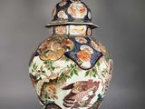 a vase with a lid that has a bird design on it