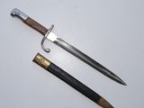 an old sword and a pencil on a white surface