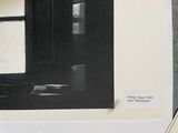 a black and white photo of a desk with a computer