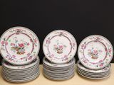 a lot of plates sitting on a table with a black background